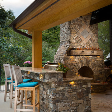 Outdoor fireplace with grill island and big green egg