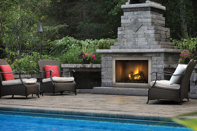 Design ideas for a small classic back patio in Philadelphia with a fire feature, brick paving and no cover.