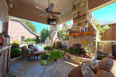 Mid-sized elegant backyard patio photo in Dallas with a fire pit and a roof extension
