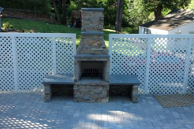 Patio - mid-sized traditional backyard concrete paver patio idea in New York with a fire pit and no cover