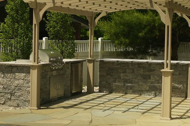 Mid-sized transitional backyard concrete patio photo in New York with a fire pit and no cover
