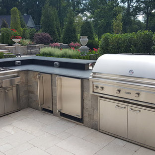 Patio kitchen - large traditional backyard stone patio kitchen idea in DC Metro with no cover
