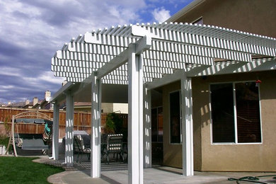 Example of a small transitional backyard concrete patio design in Los Angeles with a pergola