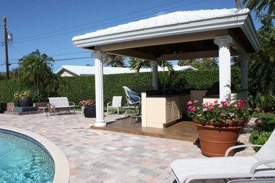 Large elegant backyard patio kitchen photo in Miami