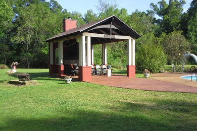 Inspiration for a large classic back patio in New Orleans with an outdoor kitchen, concrete paving and a gazebo.