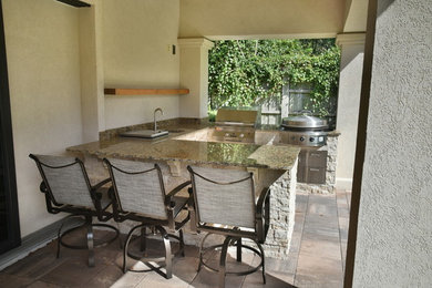 Mid-sized elegant backyard tile patio kitchen photo in Jacksonville with a roof extension