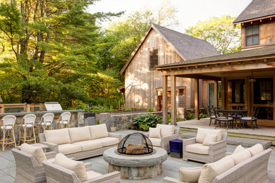 Inspiration for a large contemporary backyard concrete paver patio remodel in Boston with no cover and a fire pit
