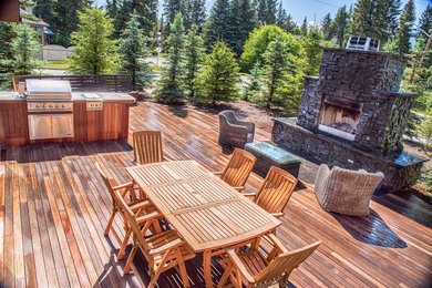 Outdoor Kitchen & Seating Space Around Rundle Stone Fireplace