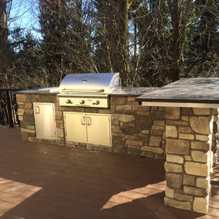 Inspiration for a timeless backyard patio kitchen remodel in Seattle with decking