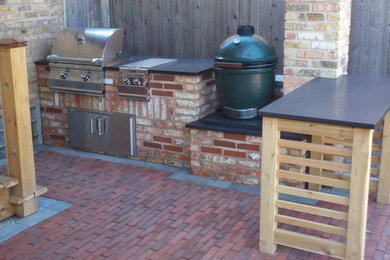 Mid-sized elegant backyard brick patio kitchen photo in Chicago with no cover