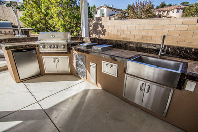 Large trendy backyard concrete patio kitchen photo in Orange County with a gazebo