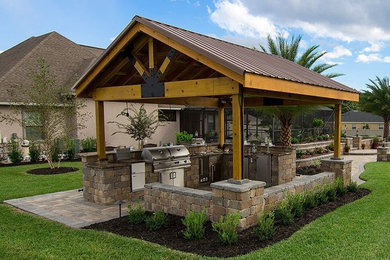 Patio kitchen - mid-sized traditional backyard concrete paver patio kitchen idea in Tampa with a gazebo