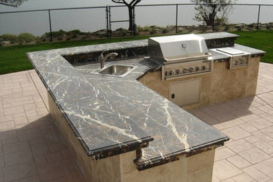 Patio kitchen - large backyard tile patio kitchen idea in San Diego with no cover