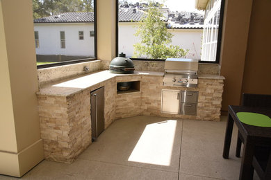 Inspiration for a medium sized traditional back patio in Jacksonville with an outdoor kitchen, concrete slabs and a roof extension.