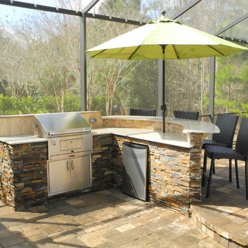 Outdoor Kitchen with curved bar and charcoal grill.