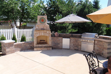 Mid-sized southwest backyard concrete patio photo in Chicago with a fire pit and no cover