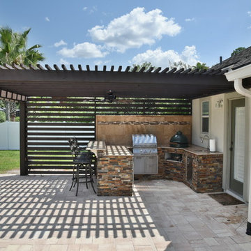 Outdoor kitchen with Solaire infrared grill, Big Green Egg, fire pit and pergola