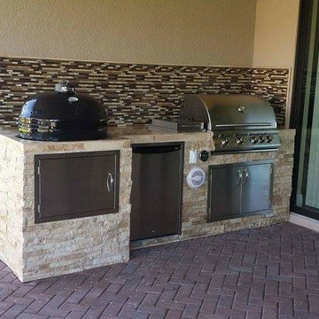 Outdoor Kitchen with Stacked Stone Exterior and Primo Oval