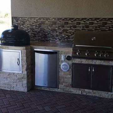 Outdoor Kitchen with Stacked Stone Exterior and Primo Oval