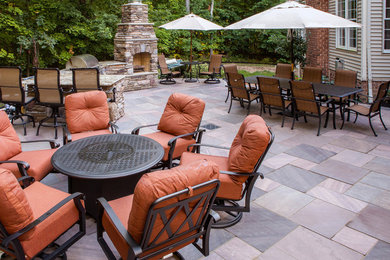 Design ideas for a large traditional back patio in Cleveland with an outdoor kitchen, tiled flooring and no cover.