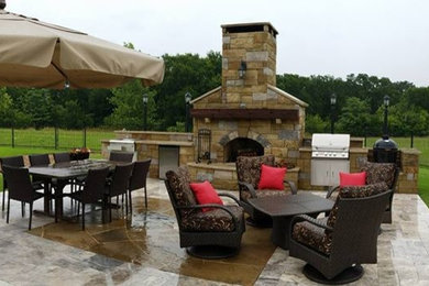 Inspiration for a large timeless backyard patio remodel in Dallas with a fire pit and no cover