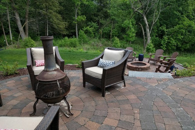 Inspiration for a mid-sized timeless backyard concrete paver patio remodel in Minneapolis with a fire pit and no cover