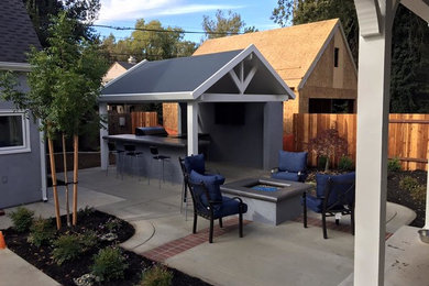 Large cottage backyard concrete paver patio kitchen photo in Sacramento with a gazebo