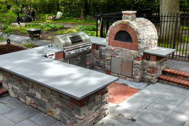 Inspiration for a large classic back patio in Grand Rapids with an outdoor kitchen, concrete paving and no cover.
