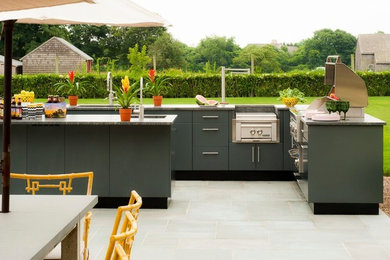 Inspiration for a mid-sized contemporary backyard concrete paver patio kitchen remodel in Orange County with no cover