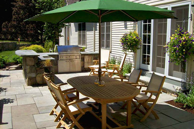 Design ideas for a medium sized traditional back patio in Boston with an outdoor kitchen, tiled flooring and no cover.