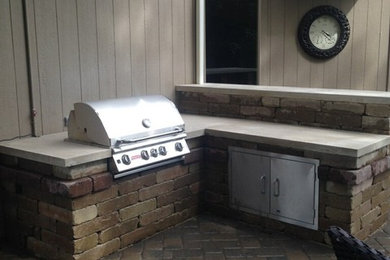 Mid-sized elegant backyard concrete paver patio kitchen photo in Kansas City with no cover