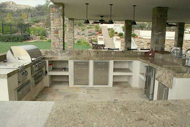 Large classic back patio in Austin with an outdoor kitchen, concrete slabs and no cover.