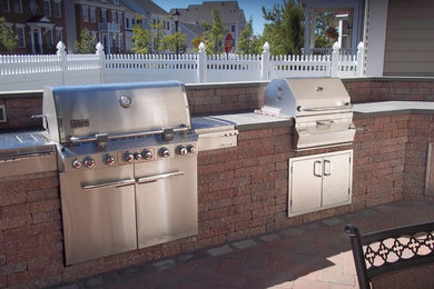 Patio kitchen - large traditional backyard brick patio kitchen idea in New York with no cover