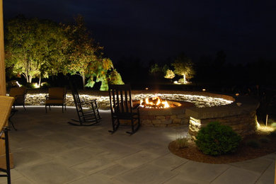 Large elegant backyard concrete paver patio photo in New York with a fire pit and no cover