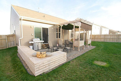Inspiration for a contemporary backyard stamped concrete patio remodel in Omaha