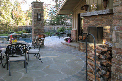 Example of a huge country backyard stone patio design in San Francisco with a fire pit and a pergola