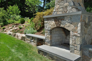Inspiration for a timeless backyard patio remodel in New York with a fire pit