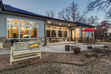 Example of a mid-sized classic backyard concrete patio design in Dallas with no cover