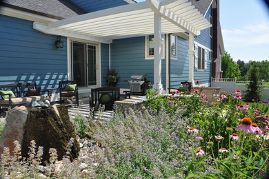 Example of a small classic backyard concrete patio design in Kansas City with a pergola