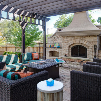 Large trendy backyard concrete paver patio photo in Chicago with a pergola and a fireplace