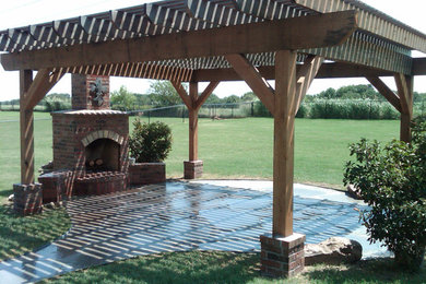 Mid-sized elegant backyard concrete paver patio photo in Oklahoma City with a fire pit and a pergola