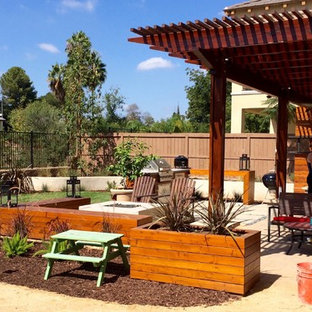 Inspiration for a mid-sized contemporary backyard concrete paver patio kitchen remodel in San Diego with a pergola
