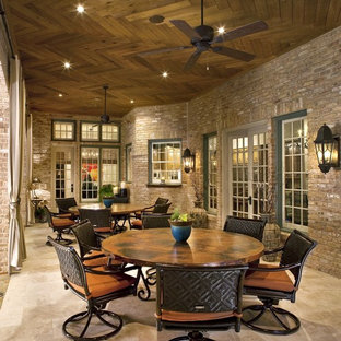 Example of a classic patio design in Dallas with a roof extension