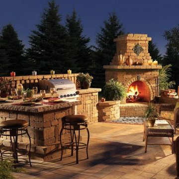 Outdoor living room by Unilock with fireplace and Umbriano paver