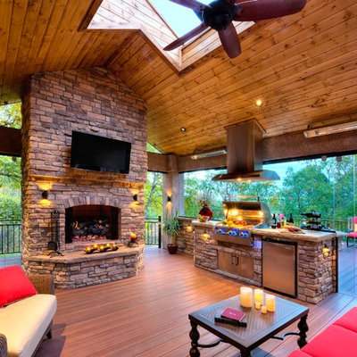 Inspiration for a large rustic backyard patio remodel in Denver with a fire pit, decking and a gazebo