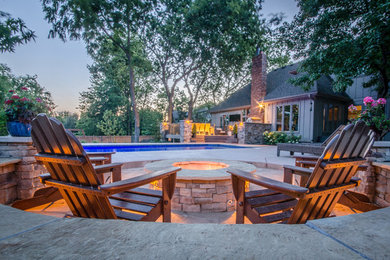 Patio - mid-sized traditional backyard concrete patio idea in Kansas City with a fire pit and no cover