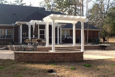 Mid-sized elegant backyard stone patio photo in Atlanta with a pergola