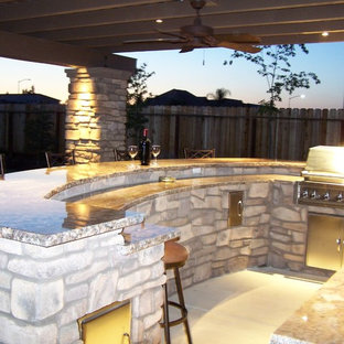 Inspiration for a mid-sized craftsman backyard concrete patio kitchen remodel in Other with a pergola