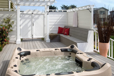 Example of a large beach style backyard outdoor patio shower design in San Francisco with decking and a pergola