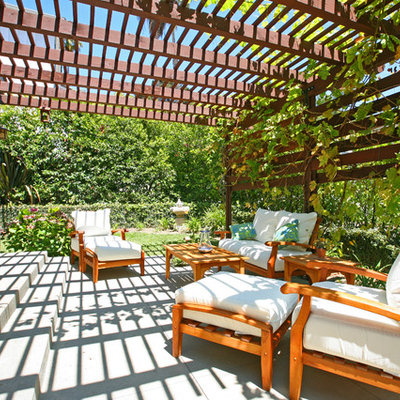 Example of a trendy backyard patio design in Orange County with a pergola